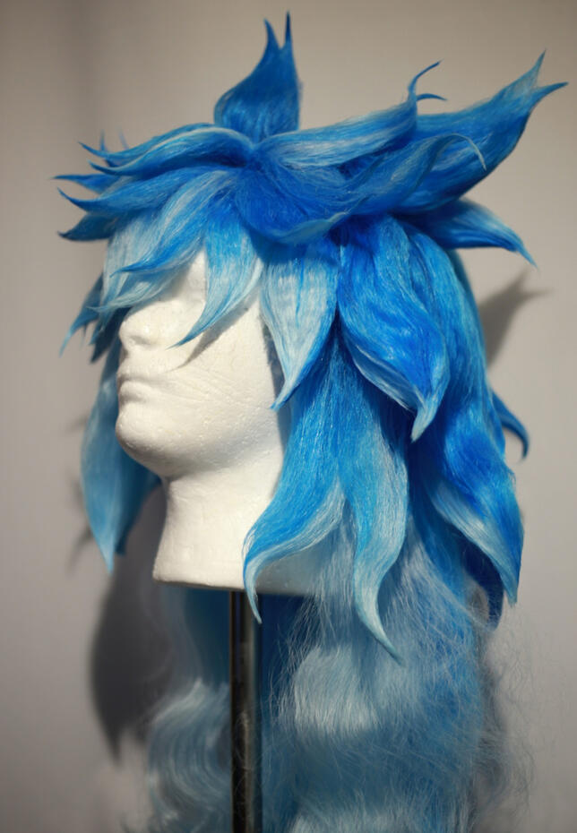 bright and light blue wig styled to look like iida from twisted wonderland