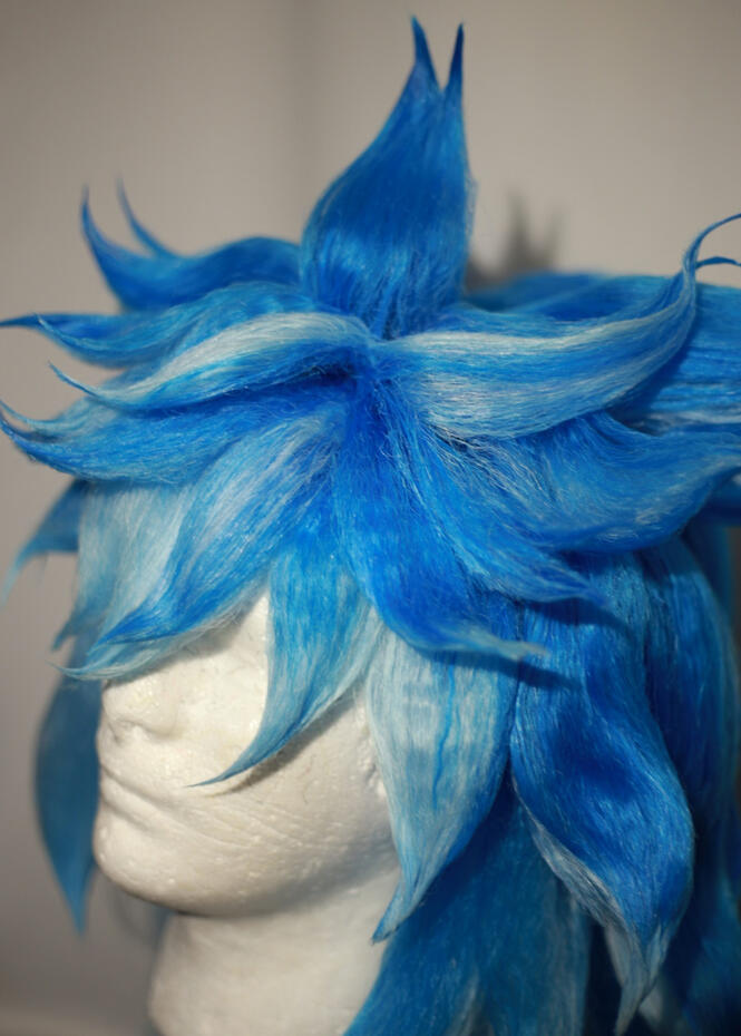 bright and light blue wig styled to look like iida from twisted wonderland